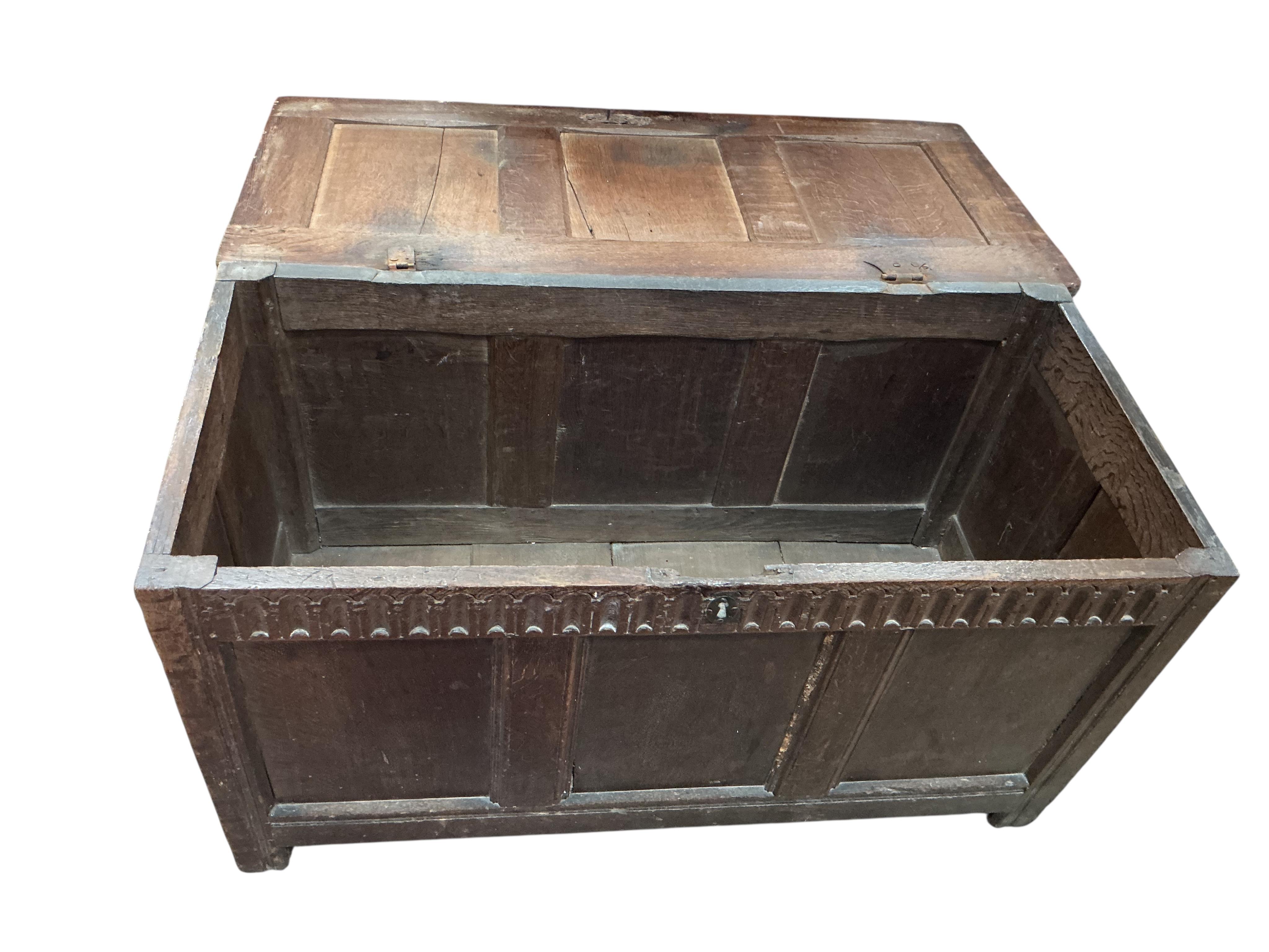 An 18th century panelled oak coffer, width 117cm, depth 54cm, height 64cm